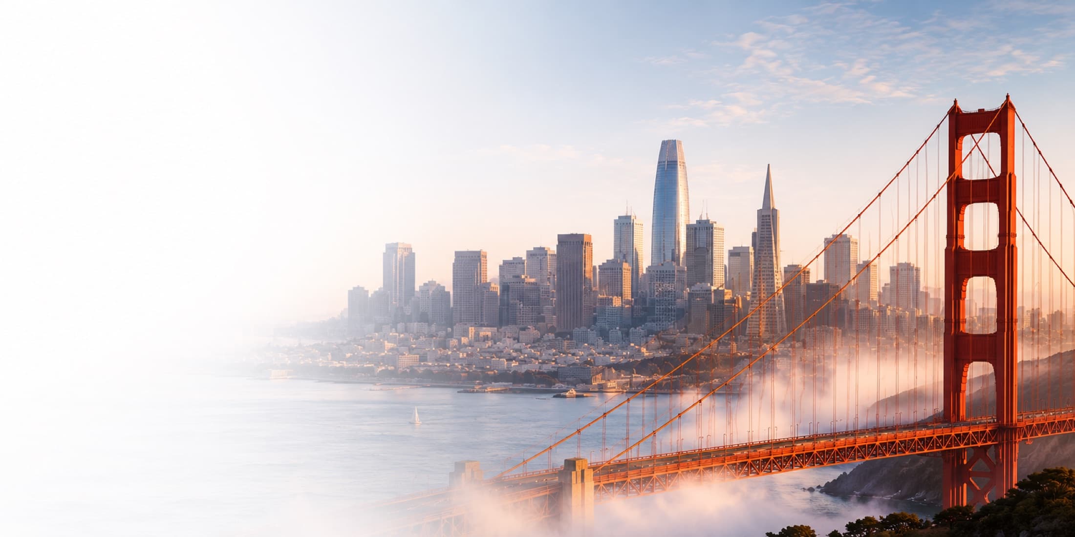 Golden Gate Bridge and the San Francisco Bay Area skyline at sunrise